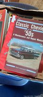 Top view of box showing the "Classic Chevrolet of the '50s" repair manual among other automotive publications.