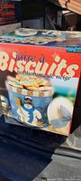 Front view of the original retail box showing the cookie jar with snowman design and the words 'Jarre à Biscuits bonhomme de neige'