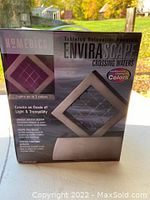 Front view of boxed HoMedics EnviraScape Crossing Waters tabletop relaxation fountain showing branding, color changing feature, and water design.