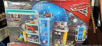 Front view of the large boxed Disney Pixar Cars 3 playset showing its vibrant blue color and multiple levels.