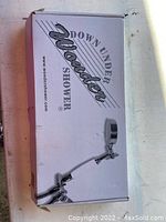 Image of original packaging box of The Original Down Under Wonder Shower showing brand name and product image.