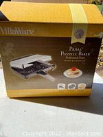 Box front view of Villaware Prima Pizzelle Baker Professional Series showing product image and branding.