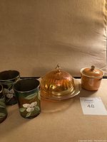 Full set showing three carnival glasses, butter dish with lid, and small container with lid