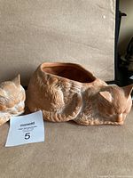 First image showing two terra cotta sleeping cat planters from a front angle, showcasing detailed fur texture and closed eyes.