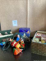 Winnie the Pooh and Tigger string lights alongside a box of multiple Christmas ribbons