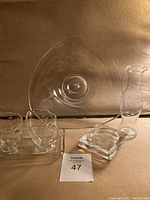 Photo showing the full lot including large triangular plate, rosebud vase, two ashtrays, and creamer and sugar on tray.