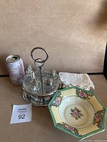 Full lot with Noritake bowl, crocheted doily, condiment tray with glass containers, and soda can for scale