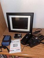 Overview of cameras, cases, digital photo frame, and Canon manual.