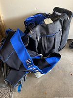 Photo showing blue and black Ocean Edge travel bag with visible wear and tear
