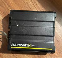 Top view of the Kicker CX 300.1 amplifier showing brand and model details on black ribbed casing.