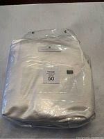 Comforter cover folded and sealed inside a clear plastic bag with label on front visible.