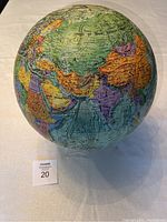 Side view of the vintage Reader's Digest 12 inch diameter globe showing detailed map of nations with land and sea relief in different colors.