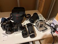 Overview of all cameras, lenses and accessories on table