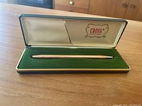 Cross gold fill pen in white and green case showing pen inside