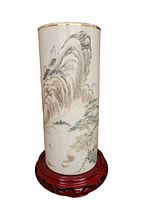 Front view of cylindrical holder showing overall painted landscape and gold-rimmed top