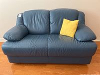 Front view of blue leather loveseat