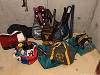Sports equipment showing CCM ice skates, tennis and badminton racquets, baseball glove, gym bags, and accessories