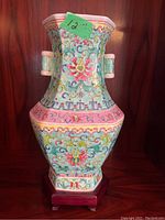 Front view of hexagonal vase on wood base