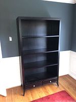 Front view of bookcase showing all shelf levels and two lower drawers