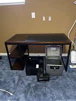 Full front view of desk showing wood top, metal frame and accessories beneath