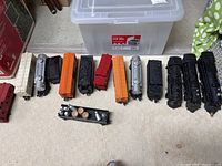 Assorted locomotives and freight cars arranged on carpet