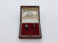 Pair of earrings displayed in an antique red-velvet presentation box