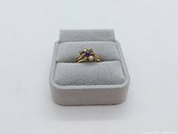 Ring displayed in grey velvet ring box, top view