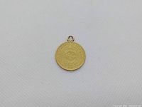 Coin displayed face-up showing mount loop