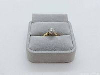 Front view of ring in gray jewelry box