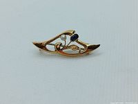 Front view of 15k gold brooch showing pearl and sapphire