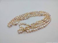 Necklace loosely coiled showing pearls and clasp from top view