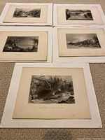 Five unframed black and white landscape prints laid out showing scenes including bridges, water, and countryside.