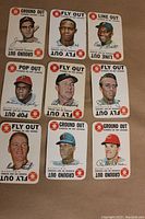 All nine 1968 Topps game cards laid out on a flat surface showing front images with player portraits, outs types, and baseball graphic symbols.