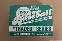 Front of the original box for the 1987 Topps Baseball Traded Series card set. The box is green and white, with the Topps logo and text indicating card numbers 1-T through 132-T. Shows some wear on edges.