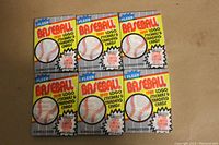 Six unopened 1989 Fleer Baseball wax packs displayed together. Packs have colorful yellow and blue design with baseball graphics.