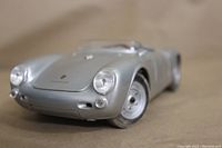 Close-up front view of the silver Porsche 550A Spyder model showing detailed headlights and front grill.