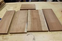 Five cherry wood boards laid out on a table showing varied widths and lengths.