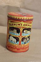 Front view of the Barnum's Animals vintage style red tin can with circus animal graphics