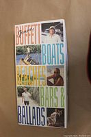 Front cover of the Jimmy Buffett box set showing title and photos of Jimmy Buffett.