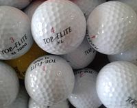 Close-up photo showing a mix of Top-Flite XL and XL 2000 golf balls with visible markings.