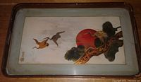 Wooden tray with Japanese style painting featuring birds flying and a red sun on a tree branch.