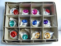 Box with 12 vintage glass Christmas ornaments in various colors, each with a central colorful indent.