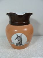 Front view of the 1920s vintage Whitbread's advertising beer jug showing the dog's head design with 'Trade Mark' banners.