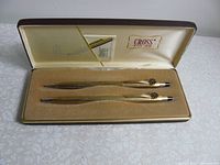 Full view of the pen and pencil set in original fitted case showing brand logo and velvet lining