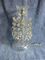 Front view of the vintage glass pendant candle holder, showing intact dangling pendants on the bottom and overall shape.