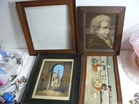 Four solid oak picture frames displayed together on a surface, three frames contain artwork and one frame is empty.