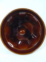 Top view showing the segmented interior and central knob of the brown ceramic monkey bread mold