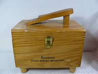 Front view of wooden box with hinged handle and latch, Ronson Roto Shine Magnetic text visible