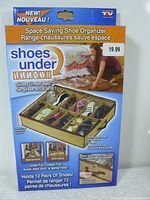 Photo of the boxed product showing a beige shoe organizer with clear cover that slides under the bed and holds 12 pairs of shoes.