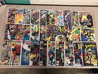 Full collection of superhero comic books laid out on a flat surface showing front covers.